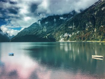 Scenic view of calm lake against mountain range