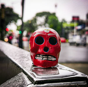 Close-up of red toy car on street