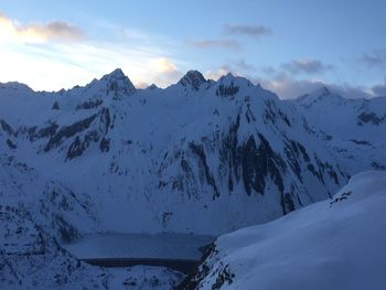 Scenic view of snow covered mountains against sky