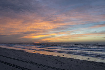 Scenic view of beach against sky during sunset