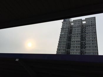 Low angle view of buildings against sky at sunset