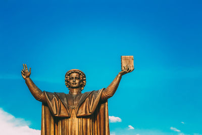 Low angle view of statue against blue sky