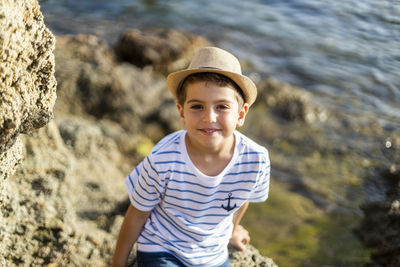 Portrait of smiling man standing on rock