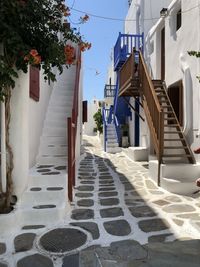 Empty alley amidst houses in city, mikonos.
