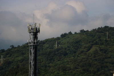 Low angle view of communications tower against sky