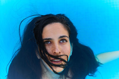 Portrait of young woman in swimming pool