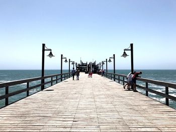 Pier over sea against clear sky