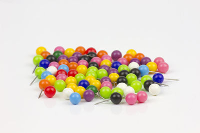 High angle view of multi colored candies against white background