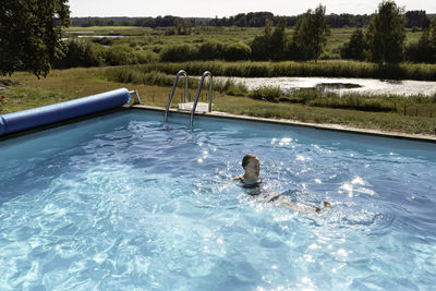 Woman swimming in swimming-pool