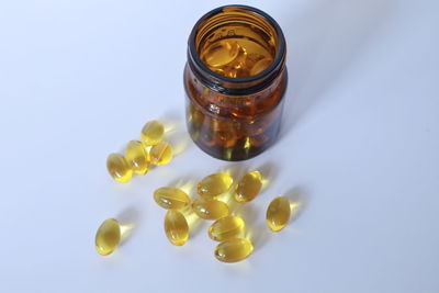 High angle view of glass bottle on white background