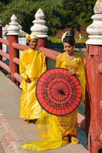 Woman with multi colored umbrellas at music concert
