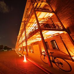 Illuminated lamp post at night