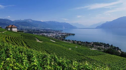 Scenic view of sea and mountains against sky