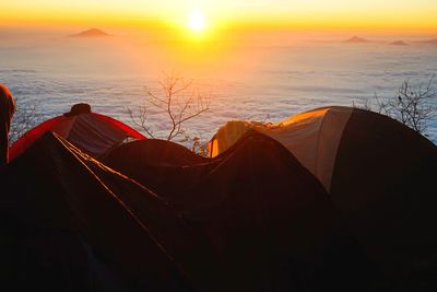 Scenic view of tent against sky during sunset
