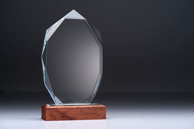 Close up of crystal trophy against gray background