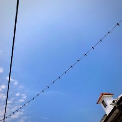 Low angle view of barbed wire against clear sky