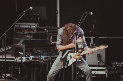 Man playing guitar at music concert