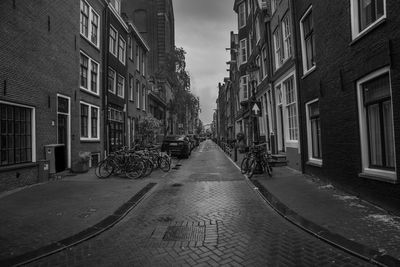 Street amidst buildings in city against sky