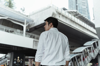 Rear view of man looking at city