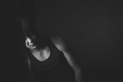 Midsection of woman dancing against black background