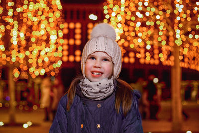 Portrait of young woman standing at night