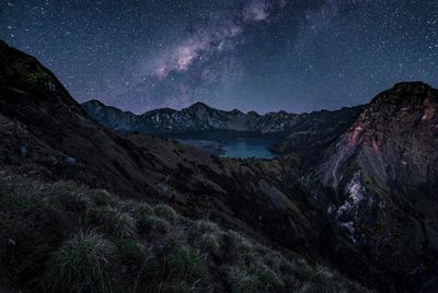 Scenic view of mountains against sky at night