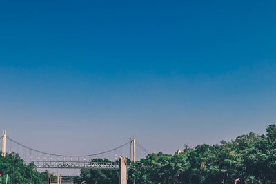 Bridge against clear blue sky in city