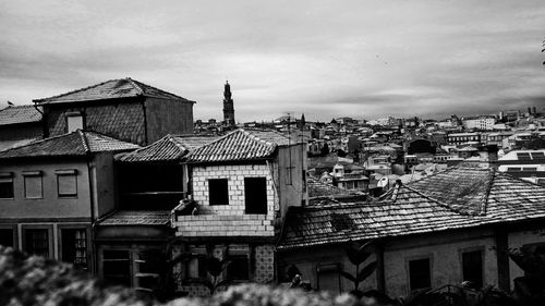 Buildings against cloudy sky