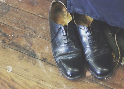 Close-up of shoes on wooden floor