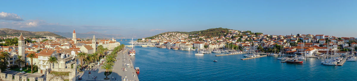 High angle view of townscape by sea against sky