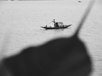 High angle view of men sitting on boat