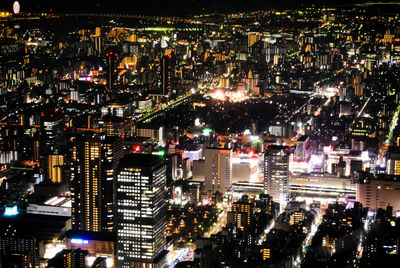 Aerial view of city lit up at night