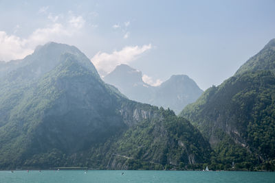 Scenic view of mountains and sea against sky