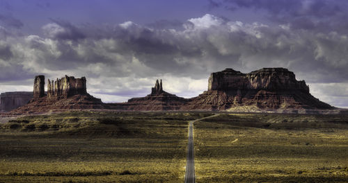 Panoramic view of rocks on field against sky