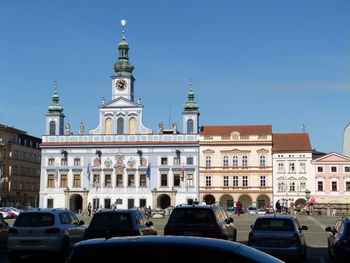 View of buildings in city against clear blue sky