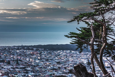 Scenic view of sea and cityscape against sky