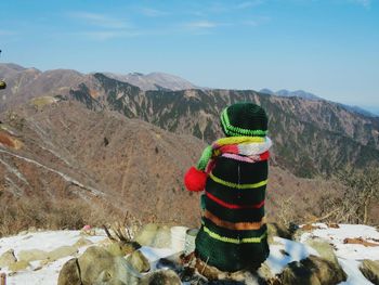 Jizo statue on mountain against sky