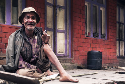 Portrait of man sitting outdoors