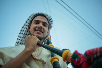  man holds a musician's instrument during the palestinian heritage day celebrations in gaza city