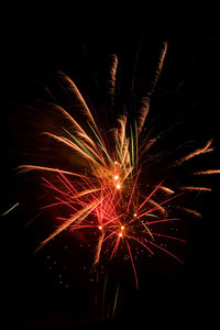 Low angle view of firework display at night