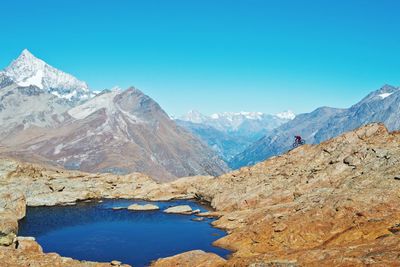 Scenic view of mountains against clear blue sky