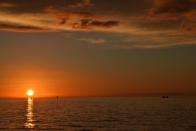 Scenic view of sea against orange sky