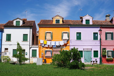 Residential buildings against sky in town