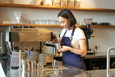 Portrait of young woman working at table