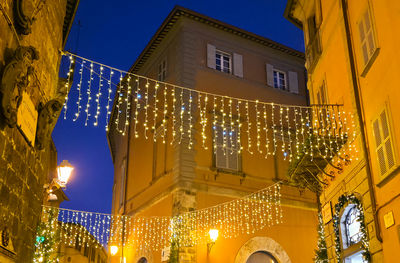 Low angle view of buildings in city at night