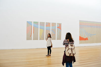 Full length of woman standing on railing
