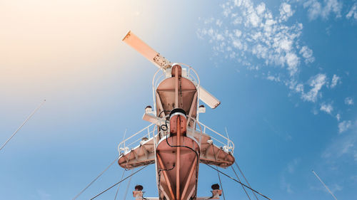 Low angle view of radar on boat against blue sky