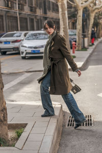 Side view of man walking on street