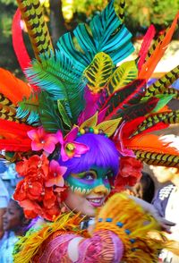 Portrait of woman with multi colored umbrellas