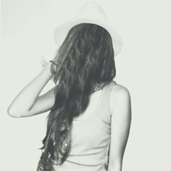 Portrait of young woman against white background